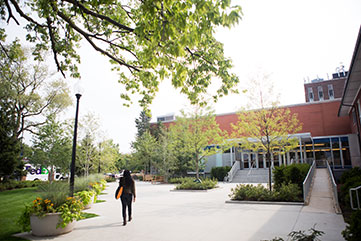 Photo of a student walking on campus. Link to Gifts by Estate Note.